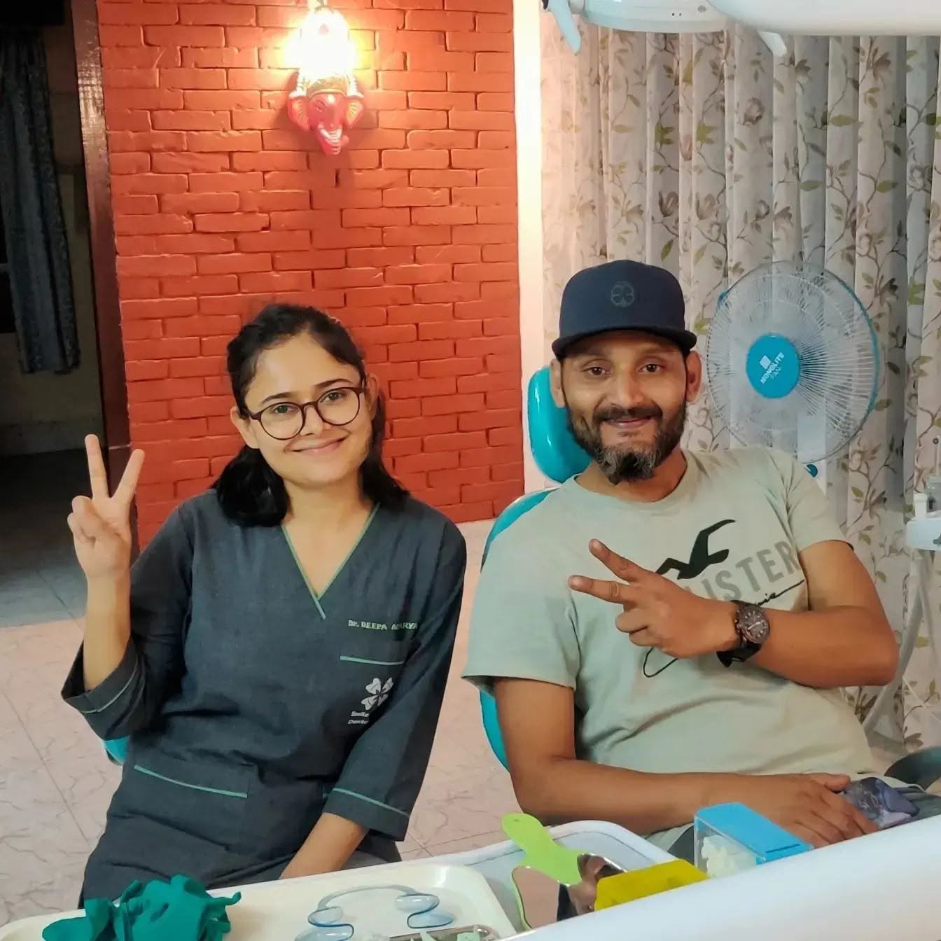 Dr. Deepa with a smiling patient at Smile Garden