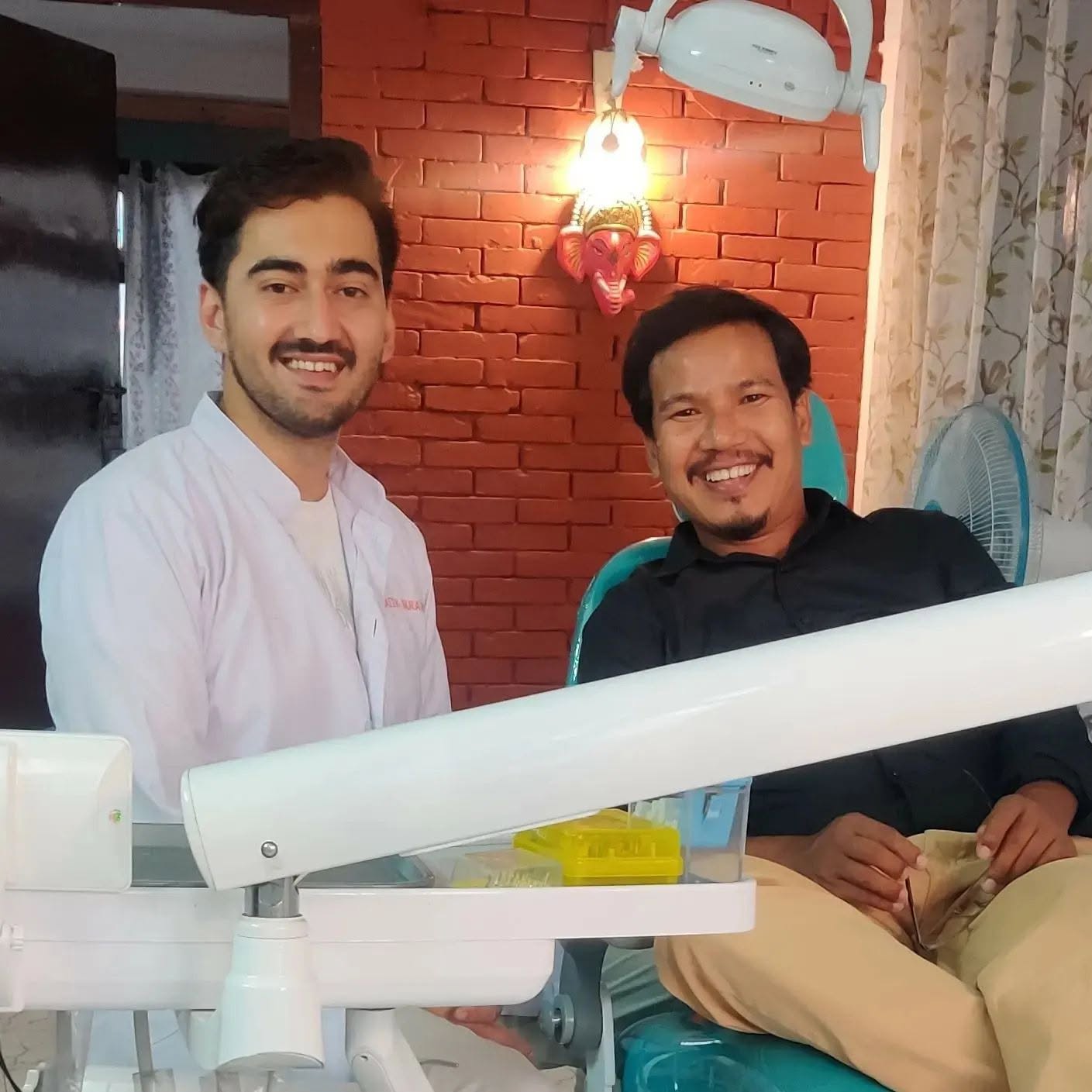 Our dentist with a happy patient after treatment