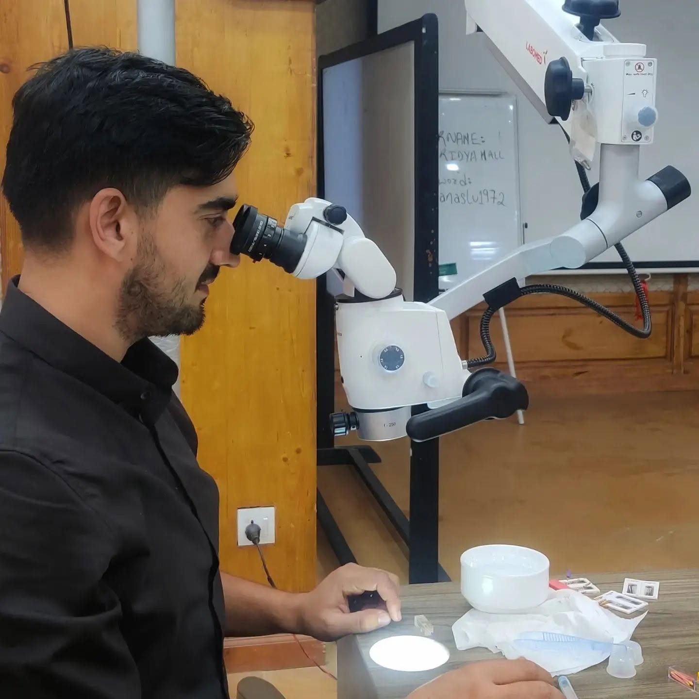 Dr. Pratik, Co-Founder of Smile Garden Dental Clinic, working with a dental microscope